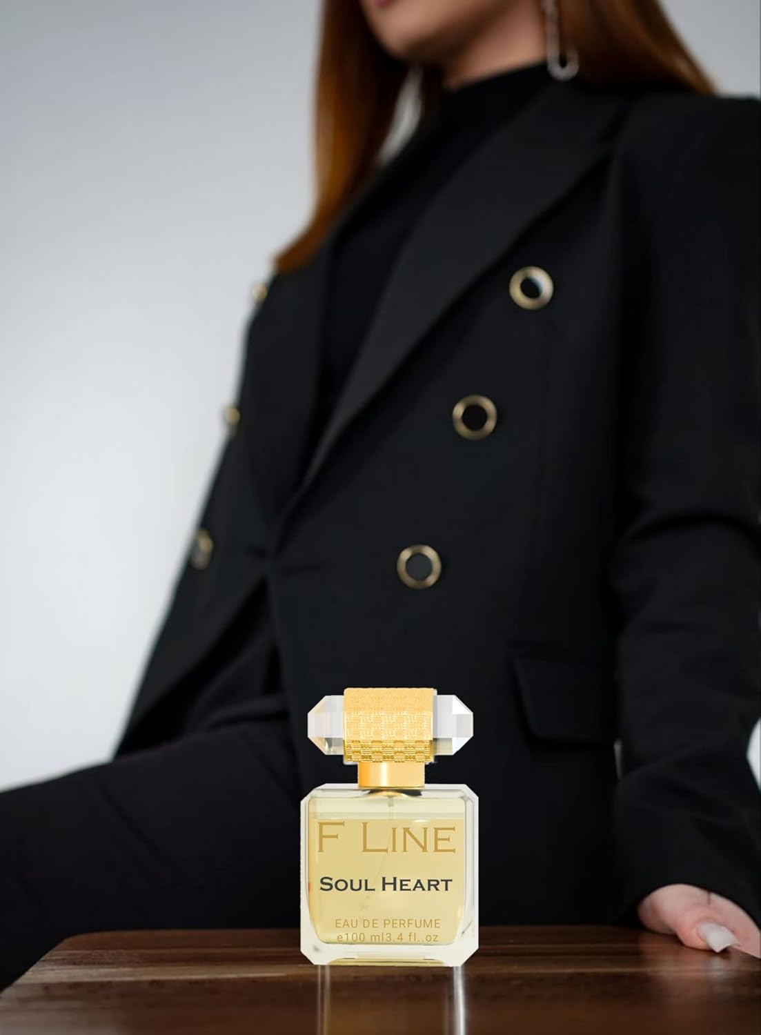 F Line Soul Heart unisex long-lasting perfume displayed beside a model wearing a stylish black blazer