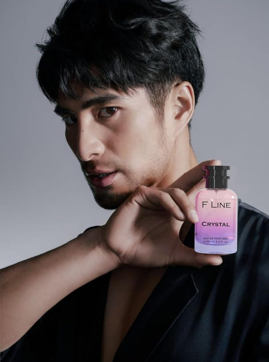 F Line Crystal premium fragrance for men and women in a stylish bottle held by a model